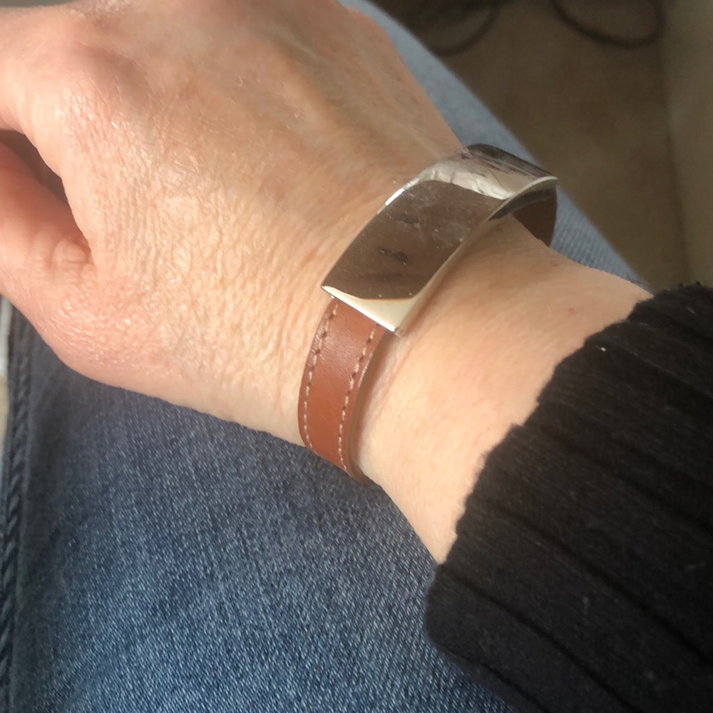 Leather band, silver toned bracelet.
